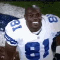 a football player wearing a white jersey with the number 81 on it