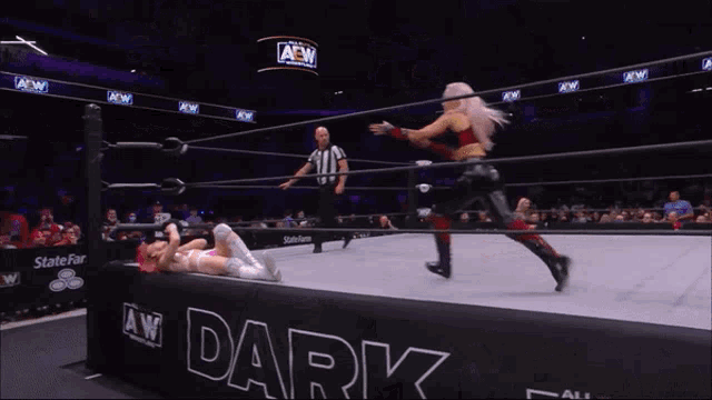 a woman is wrestling another woman in a ring that says aew dark