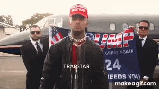 a man wearing a trump hat is standing in front of a private jet and holding a trump sign .