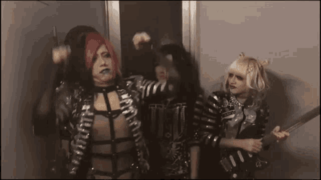 a group of people are standing next to each other in a room .