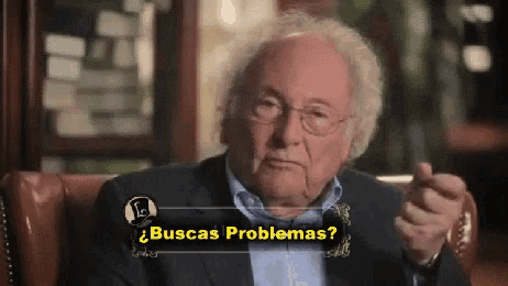 a man sitting in a chair with the words buscas problemas on the bottom