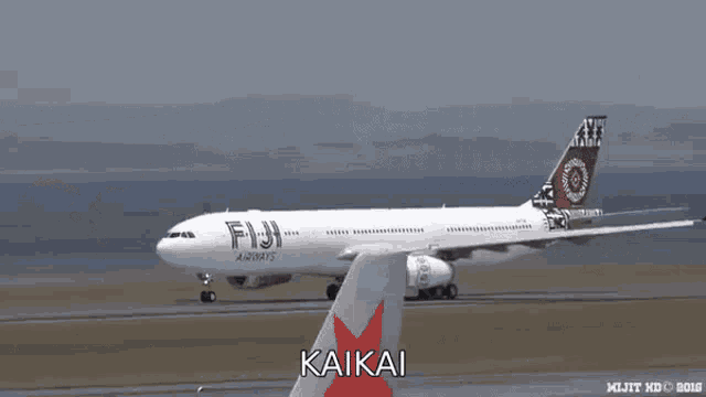 a fiji airways airplane is on the runway