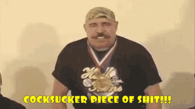 a man with a medal around his neck says " cocksucker piece of shit !!! "
