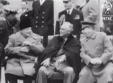 a group of men are gathered in front of a sign that says pathe