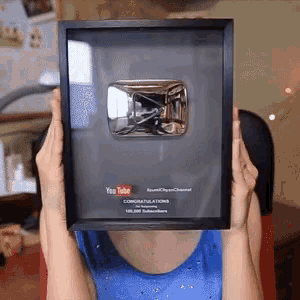a woman is holding a framed plaque that says youtube
