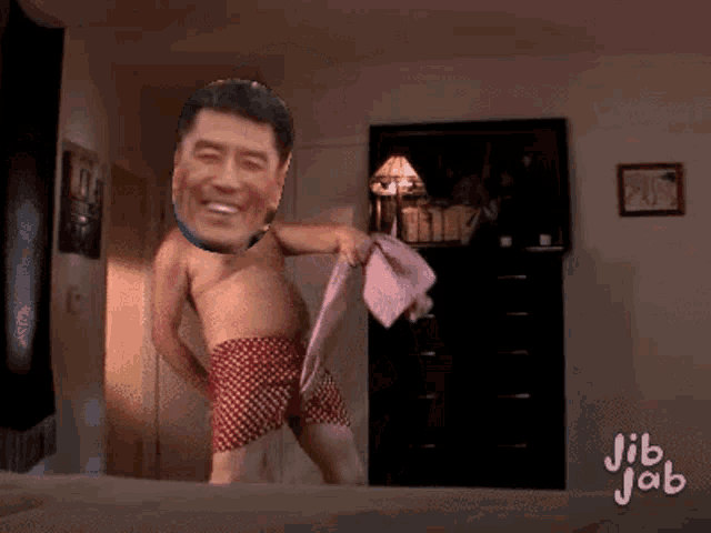 a man without a shirt is dancing on a bed with jib jab written in the corner