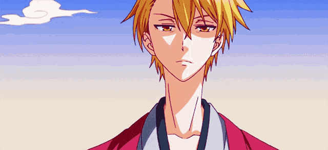 a man with yellow hair is wearing a red jacket with a blue collar