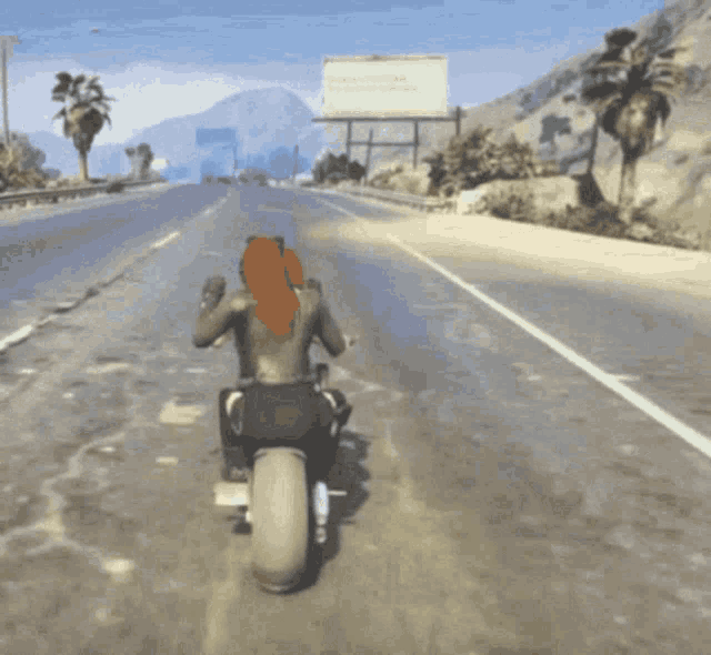 a person riding a motorcycle down a road with a billboard in the background