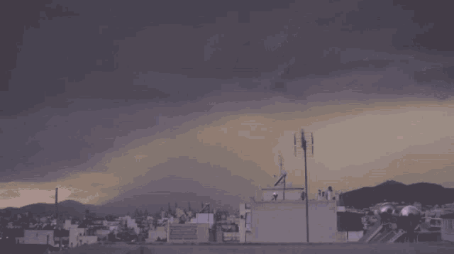 lightning strikes over a city with a purple sky in the background