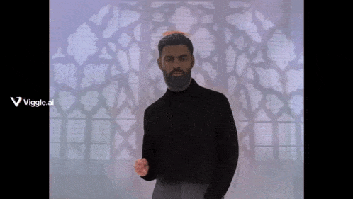a man in a black shirt is standing in front of a window with a viggle.ai logo on the bottom right