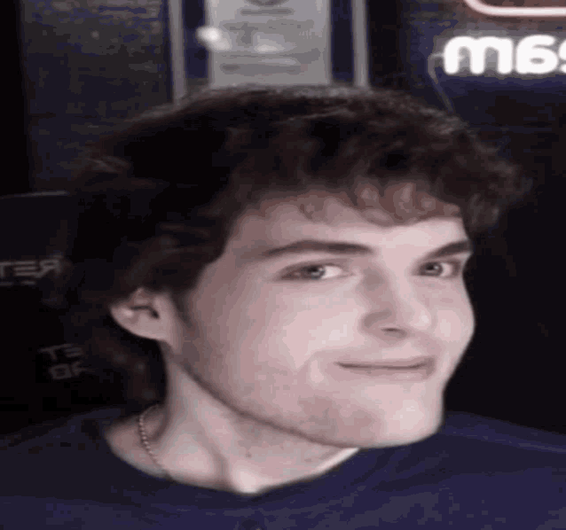 a close up of a man 's face with a sign in the background that says ts of