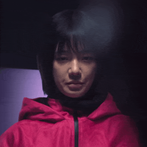 a woman wearing a red jacket with a hood