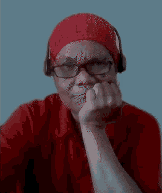 a pixelated image of a woman wearing a red shirt and headphones