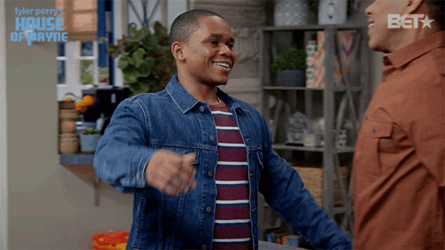 a man in a denim jacket is hugging another man in a house of payne advertisement