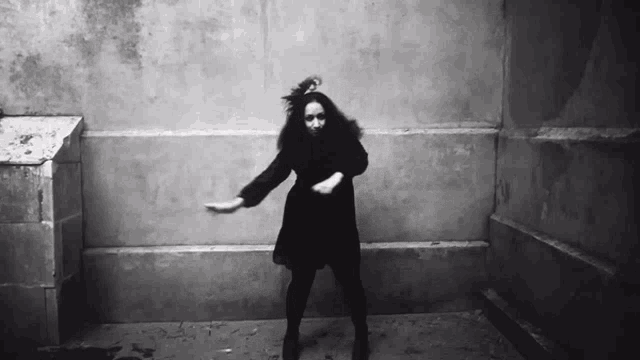 a black and white photo of a woman dancing