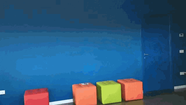 a boy in a superman costume jumps in the air