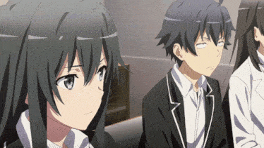 a boy and a girl are sitting next to each other in a room