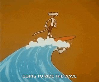the pink panther is riding a wave on a surfboard .
