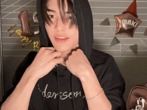 a man wearing a black hoodie with the name maki on it