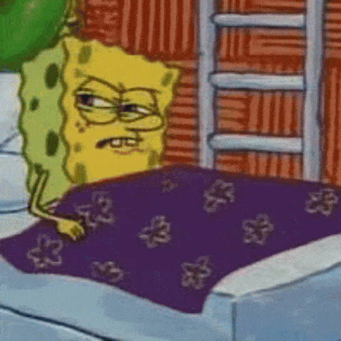 spongebob squarepants is laying on a bed with a purple blanket .