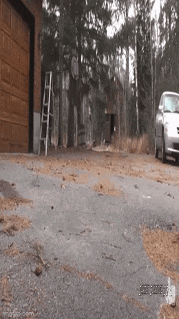 a car is parked in a driveway next to a garage