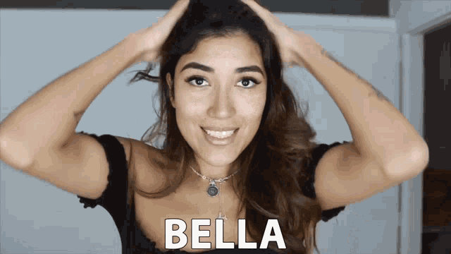 a woman is holding her hair and the word bella is on the bottom
