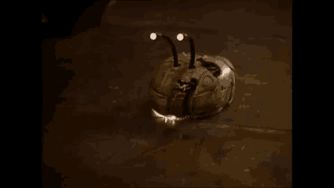 a purple light is shining on a yellow object on the ground