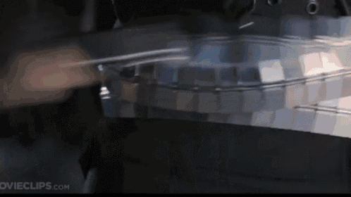 a close up of a person playing a musical instrument with the website movieclips.com in the background