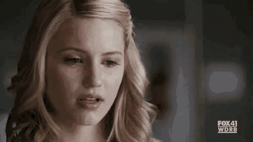 a woman is crying with a tear running down her face .