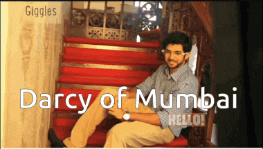 a man sits on a set of red stairs with the words darcy of mumbai written above him