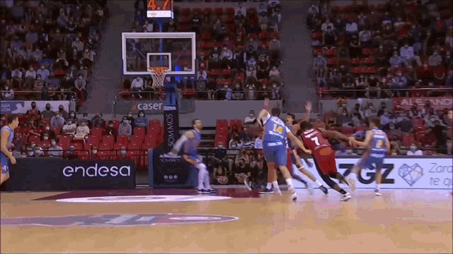 a basketball game is being played in a stadium with endesa advertisements