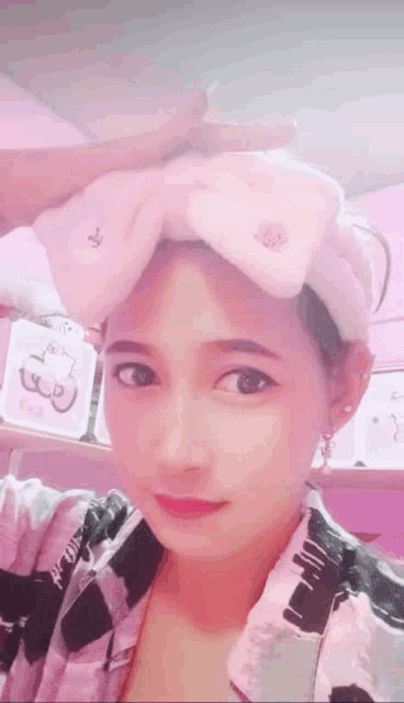 a woman is wearing a headband with a hello kitty bow on it .