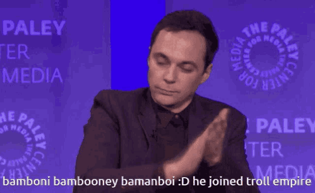 a man clapping in front of the paley center