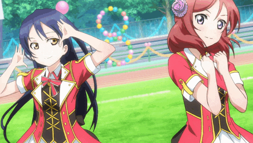 a couple of anime girls standing next to each other on a field