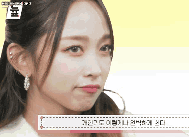 a close up of a woman 's face with the words honeycam.org at the bottom