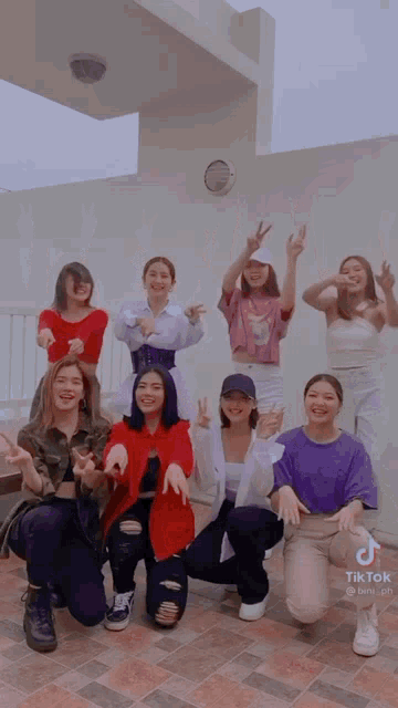 a group of young women posing for a picture with tiktok written in the corner