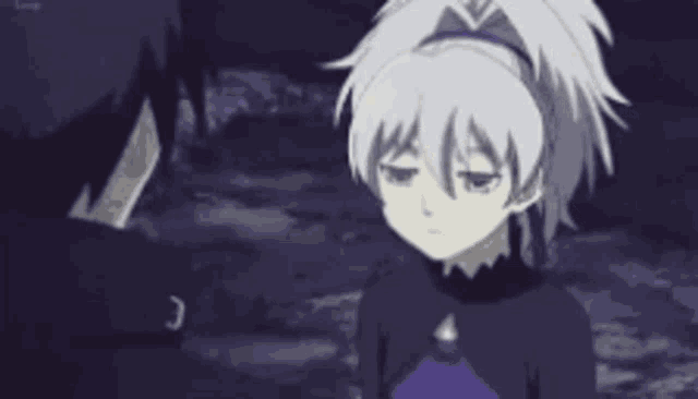 a man and a girl are standing next to each other in a dark forest .