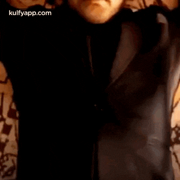 a man is laying on a bed with his eyes closed .