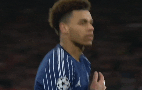 a close up of a soccer player 's face in a blurry photo