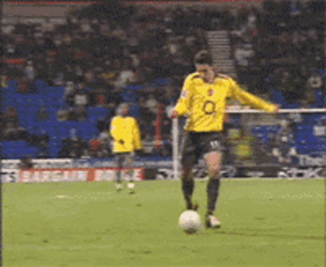 a soccer player wearing a yellow jersey with the number 0 on it