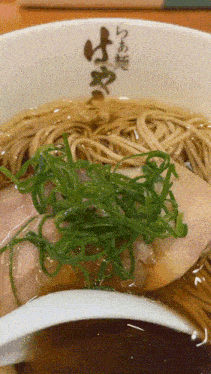 a close up of a bowl of ramen with chinese writing
