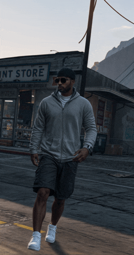 a man is walking down a street in front of a store that says ' paint store '