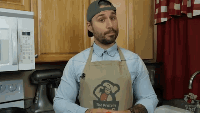 a man is wearing an apron that says the protein chef
