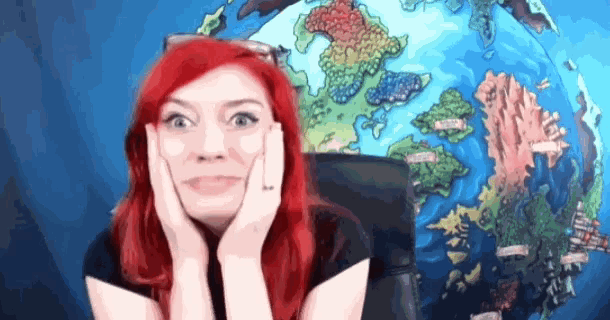 a woman with red hair has her hands on her face in front of a large globe