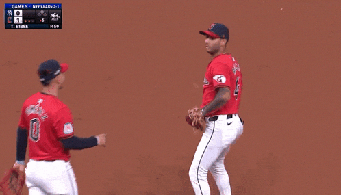 a baseball player with the number 0 on his back talks to another player