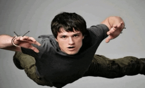 a man in a gray shirt is flying through the air