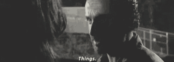 a man and a woman are talking to each other in a black and white photo and the man is saying things .