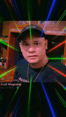 a man wearing a black hat and a black shirt with the name acell magsalay written on it