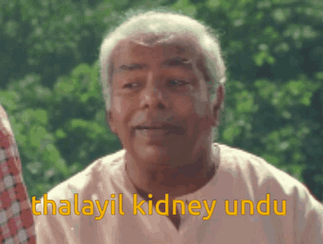 a man in a white shirt has the words thalayil kidney undu written on his face