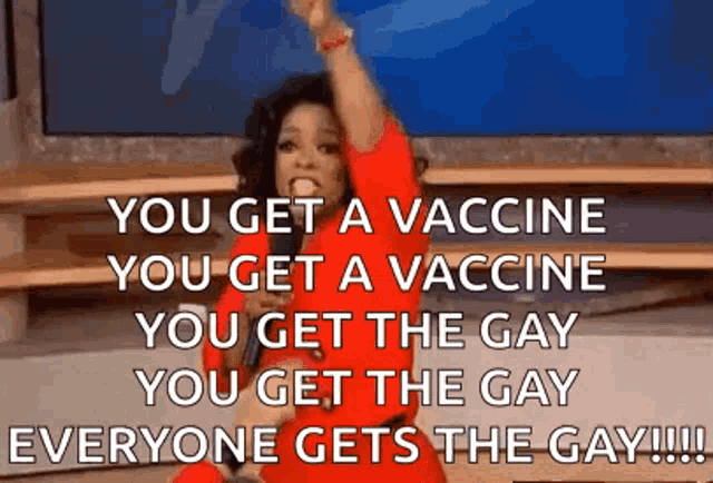 a woman in a red dress is holding a microphone and says you get a vaccine you get a vaccine you get the gay